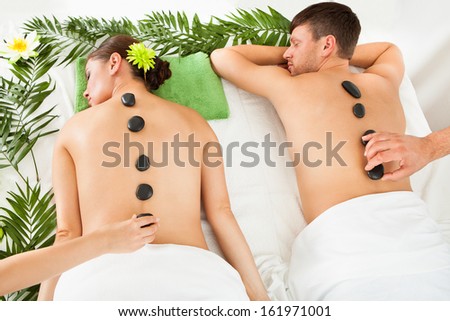 Couple Relaxing In A Spa Getting Lastone Therapy