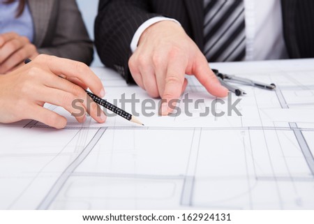 Closeup Of A Person\'s Hand Pointing On Blue Print