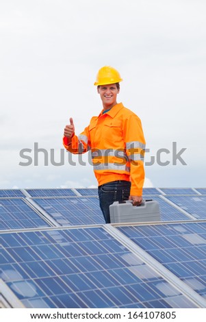Happy Engineer With Toolkit Gesturing Thumb Up Sign