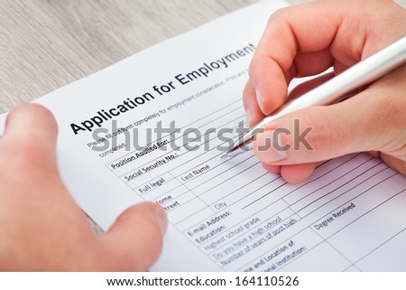 Close-up Of Hand Filling Application For Employment