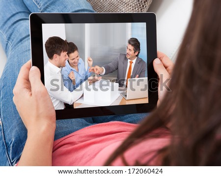 Close-Up Of A Young Woman Looking At Business Deal On Digital Tablet