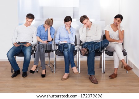 Young Group Of People Sleeping On Chair In A Waiting Room