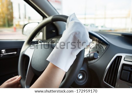 Close-up Of Hand With Glove Cleaning Steering Wheel