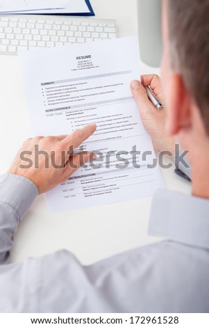 Close-up Of Person Hand Holding Curriculum Vitae