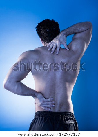 Rear View Of Young Man Suffering From Back Pain