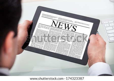 Close-up Of A Businessman Reading News On Digital Tablet