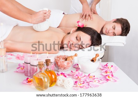 Young Beautiful Man And Woman Getting Massage In Spa