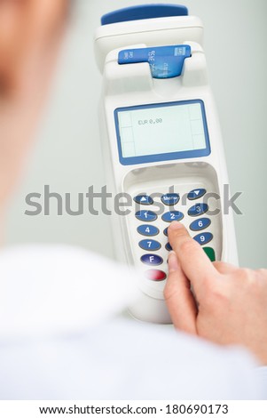 Close-up Of Person Using A Credit Card Reader