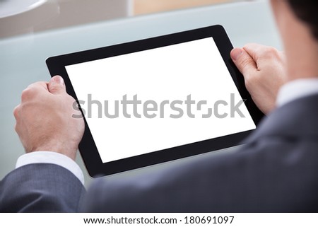 Close-up Of Businessman Looking At Digital Tablet