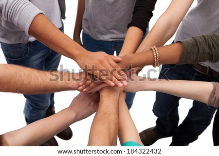 High angle view of multiethnic college students stacking hands against white background