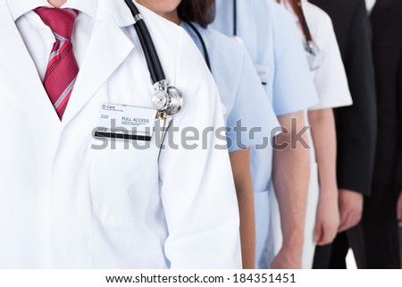 Close-up shot of doctors and business people standing in row