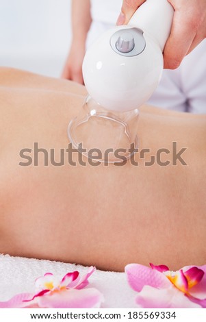 Smiling Young Woman Getting Laser Therapy In Spa