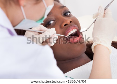 High angle view of female patient being examined by dentist in clinic