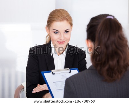 Businesswoman Conducting An Employment Interview With Young Female Applicant