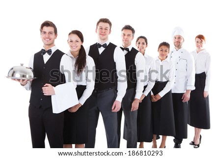 Large group of waiters and waitresses standing in row. Isolated on white