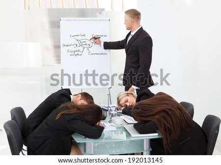 Businessman And His Colleagues Sleeping During Presentation