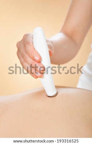 Closeup of woman receiving microdermabrasion therapy at beauty spa