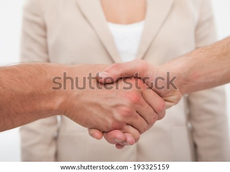 Cropped image of business colleagues shaking hands in office