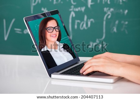Cropped image of university student attending online lecture on laptop in classroom