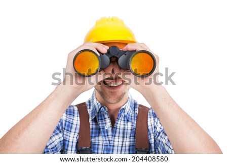 Full length of young male repairman looking through binoculars over white background