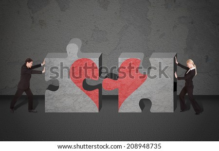 Full length side view of business people joining puzzle pieces with heart drawn on it