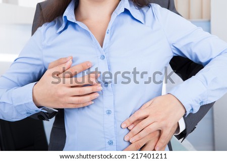 Close-up Of Businessman Embracing Businesswoman From Behind