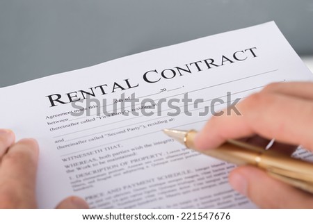 Hand filling rental contract document. Closeup shot