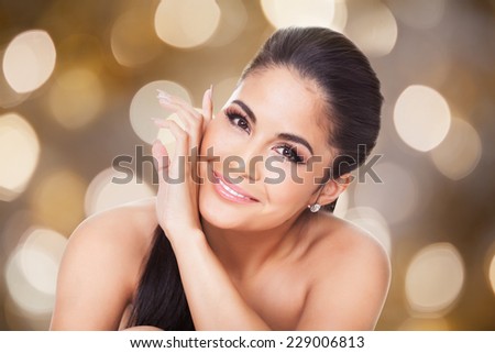 Closeup portrait of beautiful topless woman against colored background