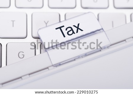 Closeup of Tax tab attached to keyboard