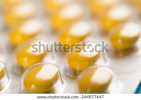 Close-up Of Yellow Pills Packed In Blisters