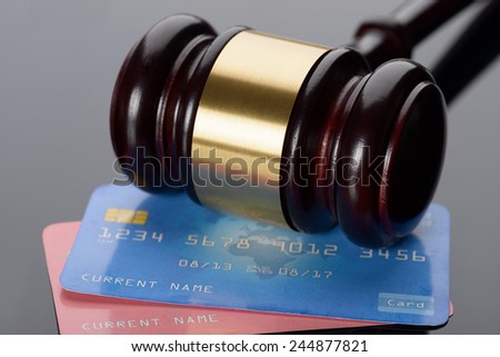 Close-up Of Wooden Brown Gavel With Credit Cards