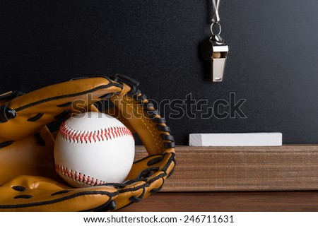 Close-up Of Blackboard With Baseball; Sport Whistle; Chalk And Leather Gloves