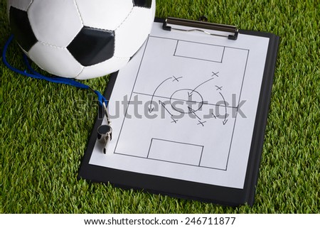 Ball; Whistle And Soccer Tactic Diagram On Paper Over Pitch
