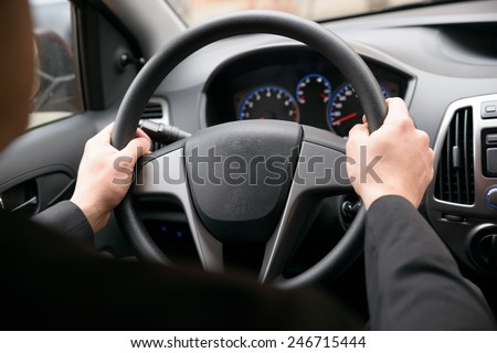 Close-up Of A Man Hands Holding Steering Wheel While Driving Car