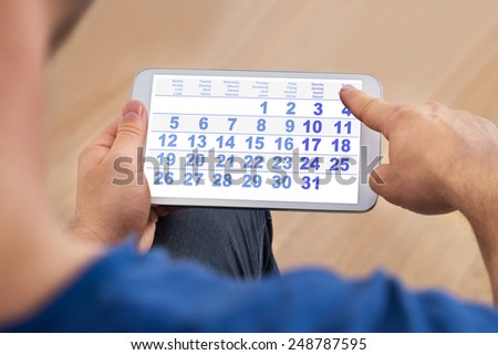 Close-up Of A Man Looking At Calendar On Smartphone
