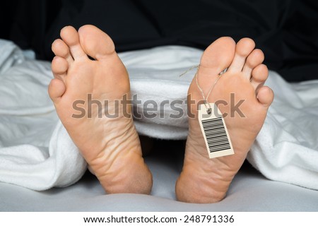 Deceased Person Covered In A Sheet With A Toe Tag