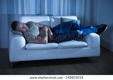 Portrait Of A Young Man Sleeping On Couch