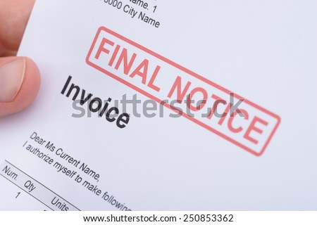 Close-up Of A Man Holding Invoice With Final Notice Stamp On It