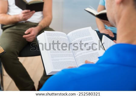 Group Of Multiethnic Friends Reading Bible Together