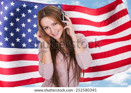 Woman Listening English Language Learning Course Audiobook In Front Of American Flag