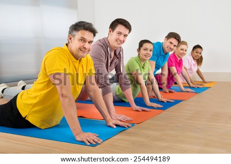 Group Of Diverse Multiethnic People Exercising On Mat