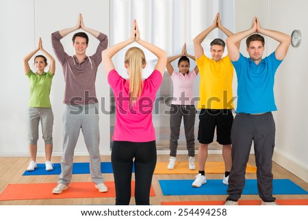 Yoga Instructor And Students At Yoga Class