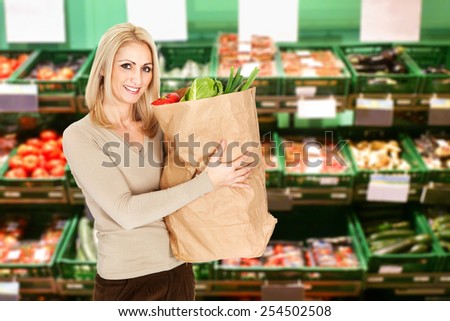 Young Woman Holding A Grocery Bag Full Of Vegetable