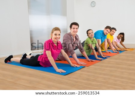 Group Of Diverse Multiethnic People Exercising On Mat