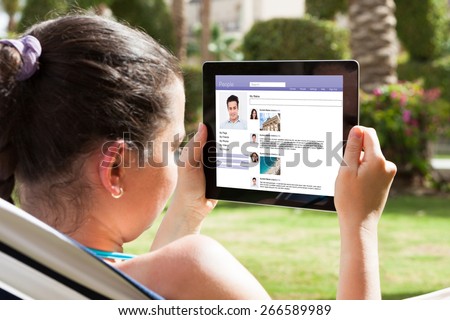 Close-up Of Young Woman Chatting On Social Site With Digital Tablet