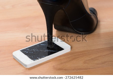 Close-up Of High Heel Step On Broken Screen Smartphone