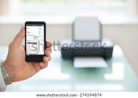 Close-up Of A Businessman Using Cellphone For Printing Invoice. Photographer owns copyright for images on screen