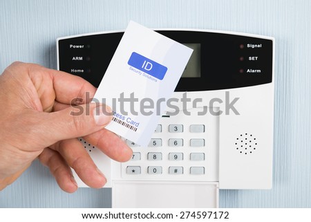 Close-up Of A Person Holding Security Card To Open Door. Photographer owns copyright for card design