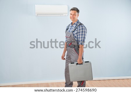Photo Of Air Conditioner Repairman With Toolkit
