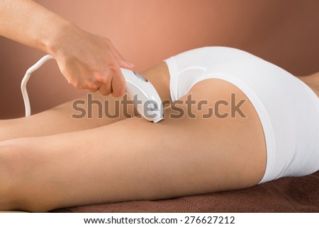 Close-up Of Woman Receiving Epilation Laser Treatment On Thigh